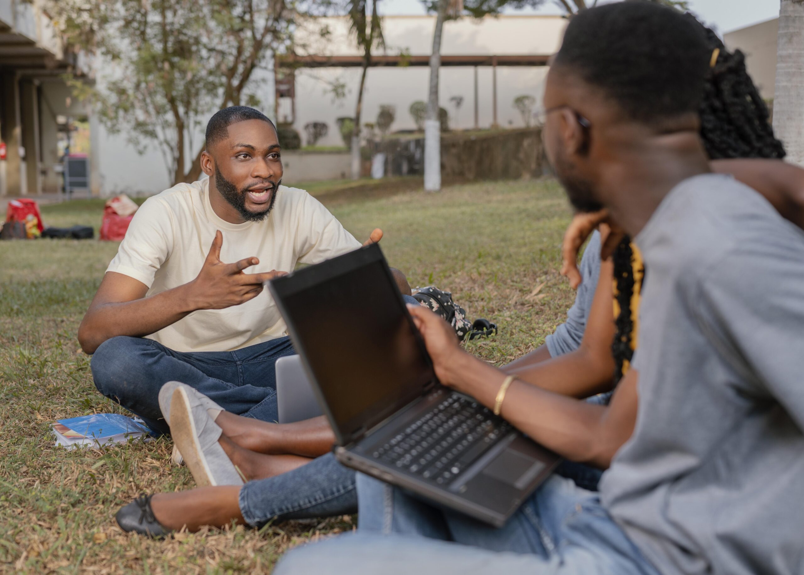 close up students learning outdoors with laptop