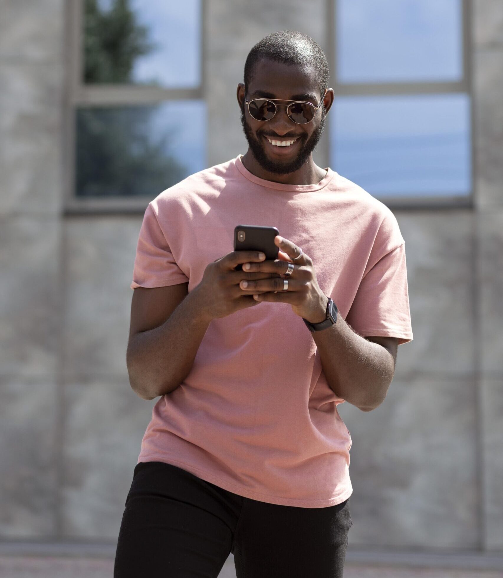 handsome man using modern smartphone outdoors